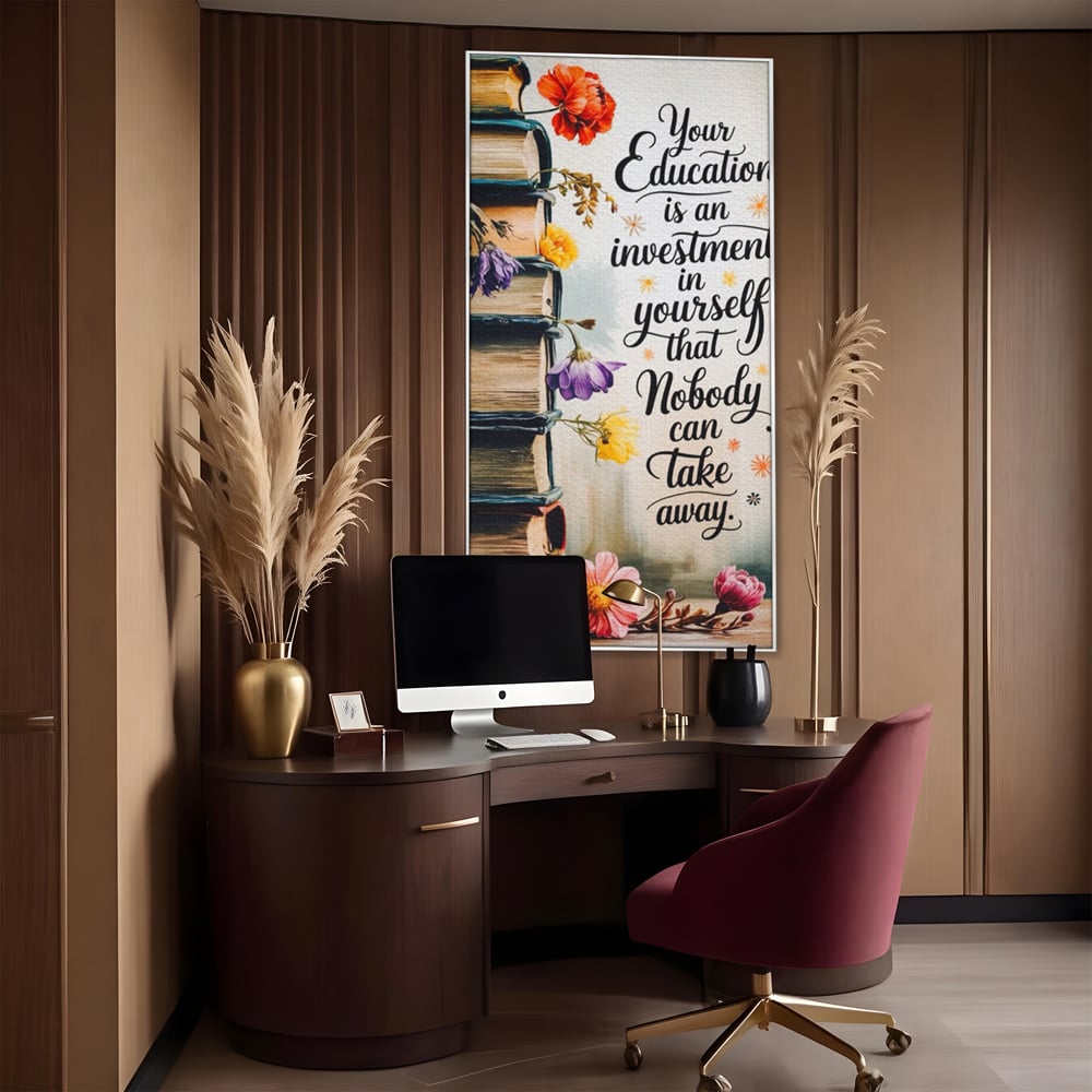 Tablou canvas cu tablou motivational cu teanc de carti si flori, in rama de aluminiu argintiu, pe perete intr-un birou